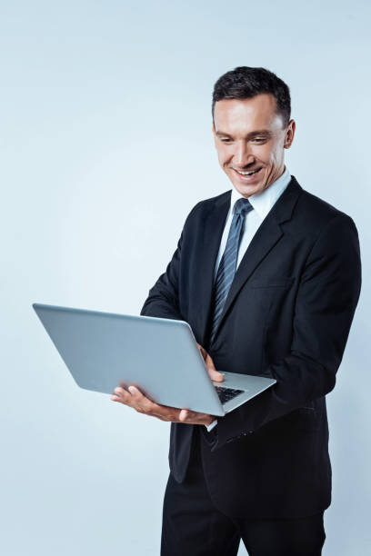 istock Radiant male in suit surfing internet on computer 847260200