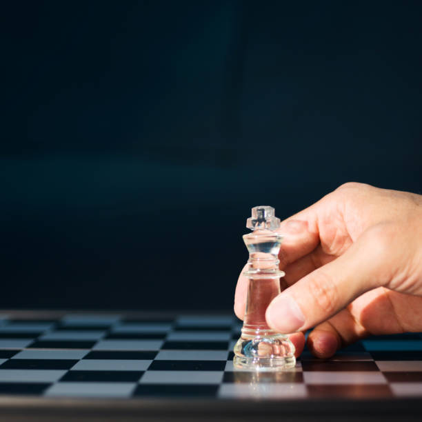 istock Human hand holding king chess on the black background 847261148