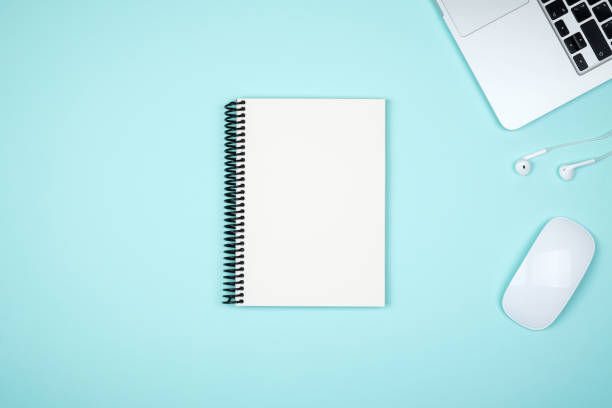 istock Minimal workplace with laptop and blank notepad on colored background. Top view. Flat lay 847261538