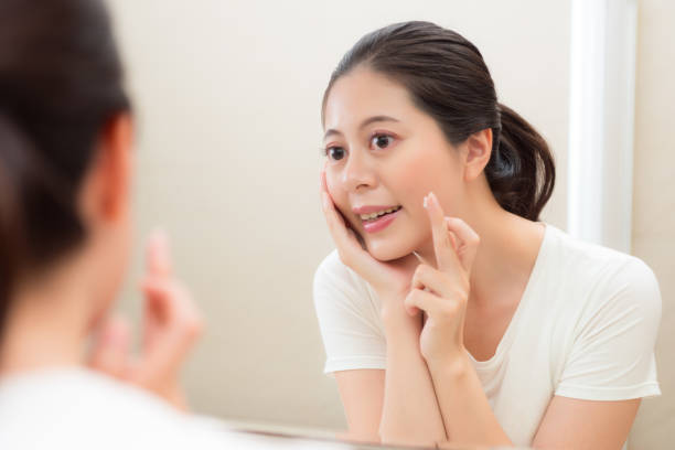 istock beautiful attractive woman checking face skin 847265270