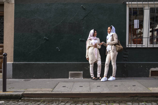 Arab youth in Paris - Middle eastern Millennials walking down the street of the capital of France.