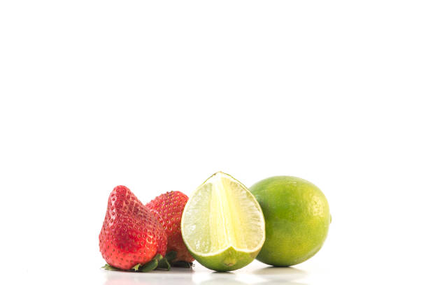 Green lime fruit and strawberry isolated on white background stock photo