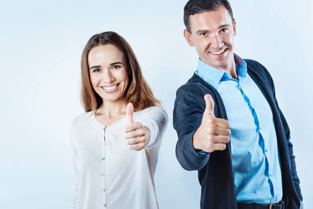 istock Joyful people thumbing up into camera 847276468