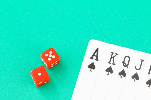 istock Dices and cards on green casino table 847276788