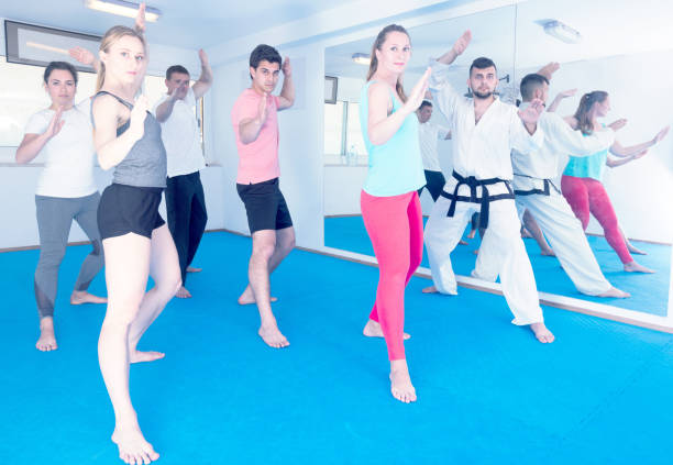 istock Adults trying new martial moves at karate class 847280550
