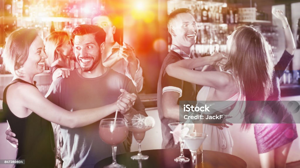 Female with man are dancing in bar Female with man are dancing in pair on the party in the bar Night Stock Photo