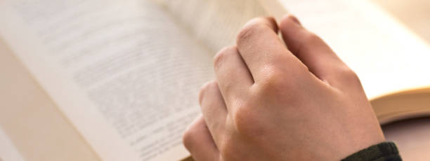istock Reading a Book. Young Boy Sitting on Table at Home and Studying. Morning With a Book in Hands. 847290742
