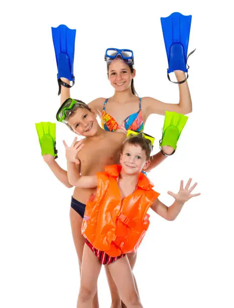 Photo of Three funny kids in diving mask standing together