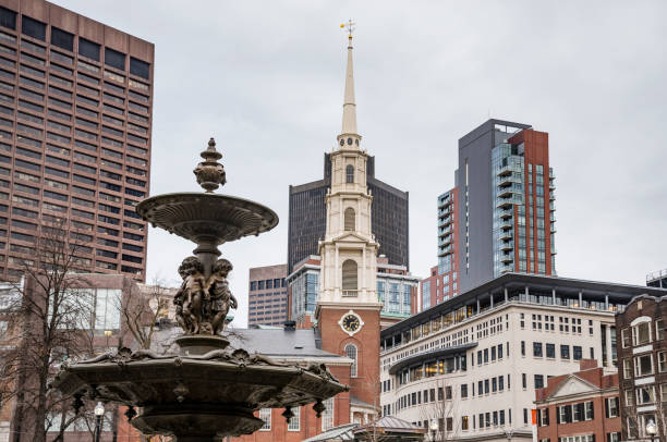 Brewer fountain (dates back to 1868) and golden dome of Massachusetts State Capitol (dates back to 1795) in Boston Common Park which is a public park in downtown Boston, Massachusetts.