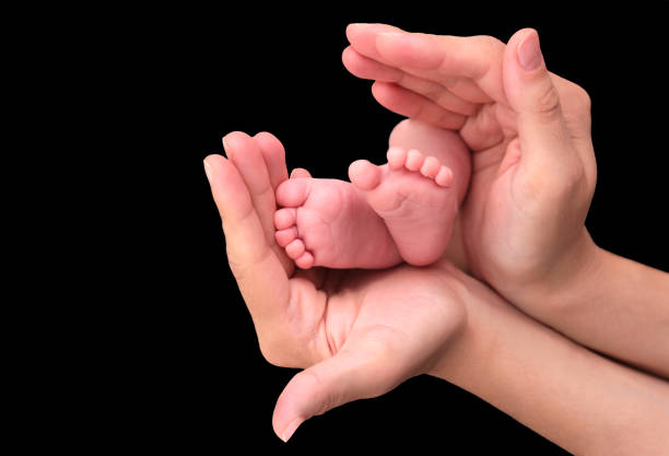 istock Baby foot in mother hands 847308546