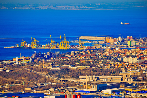 City of Trieste aerial view of industrial zone and harbor, capital of Friuli Venezia Giulia region in Italy