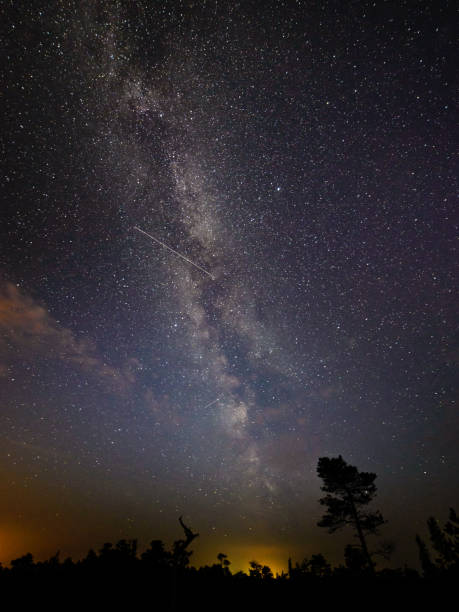 istock colorful milky way galaxy seen in night sky over trees 847322594
