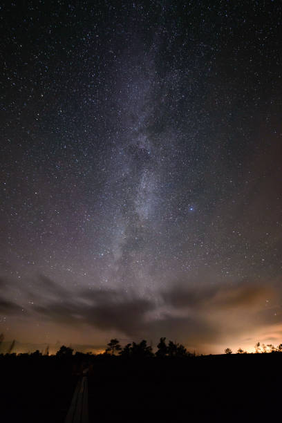 istock colorful milky way galaxy seen in night sky over trees 847322778