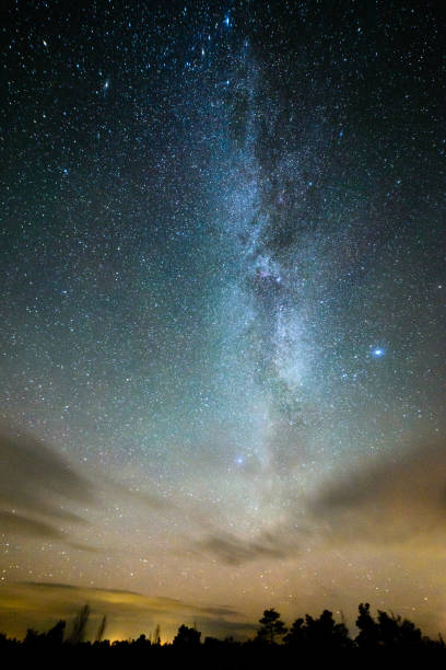 istock colorful milky way galaxy seen in night sky over trees 847323020