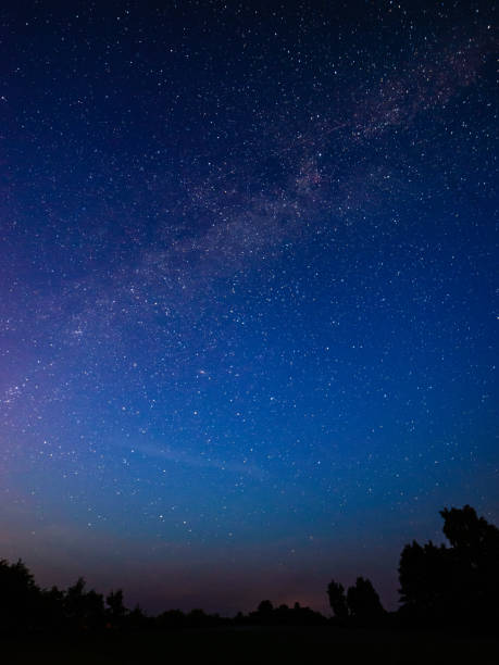istock colorful milky way galaxy seen in night sky over trees 847323092