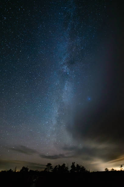 istock colorful milky way galaxy seen in night sky over trees 847325222
