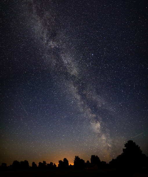 istock colorful milky way galaxy seen in night sky over trees 847325254