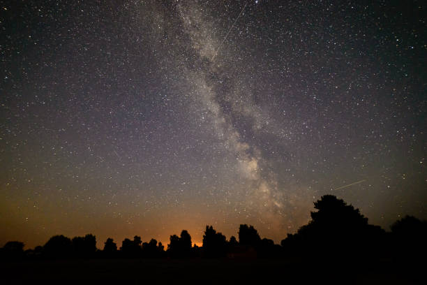 istock colorful milky way galaxy seen in night sky over trees 847325256