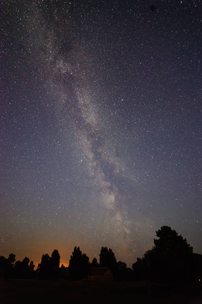istock colorful milky way galaxy seen in night sky over trees 847325270