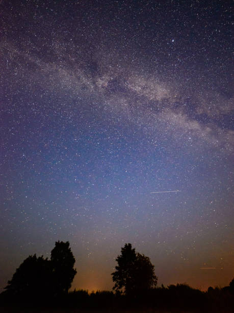 istock colorful milky way galaxy seen in night sky over trees 847325434