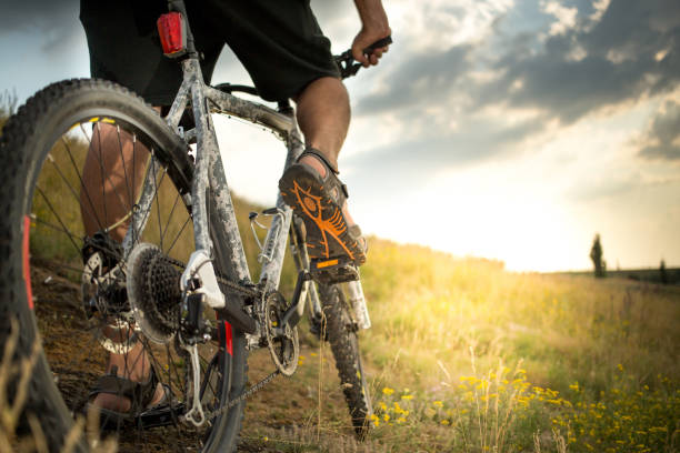 Man biking outdoors Man biking outdoors with beautiful evening light mountain biking stock pictures, royalty-free photos & images