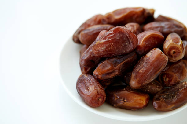 istock Bowl of dried dates isolated on white Background 847330054