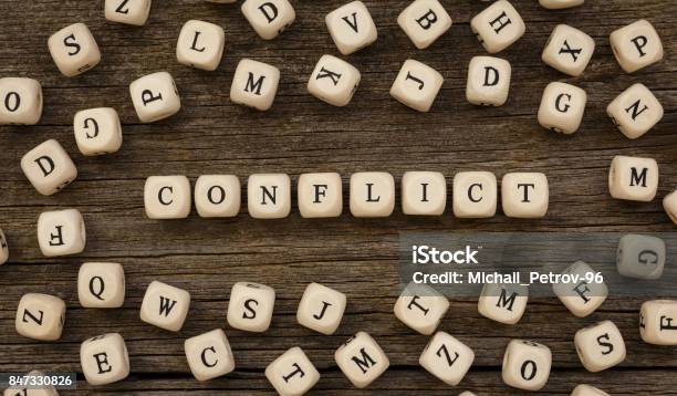 Word Conflict Written On Wood Block Stock Photo - Download Image Now - Conflict, Curiosity, Interest Rate