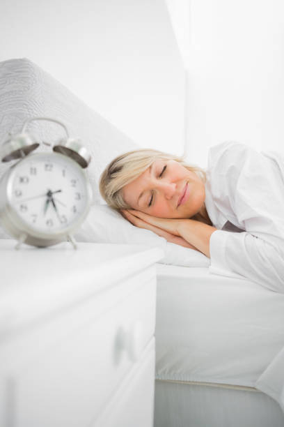 istock Blonde woman in bed asleep 847330884