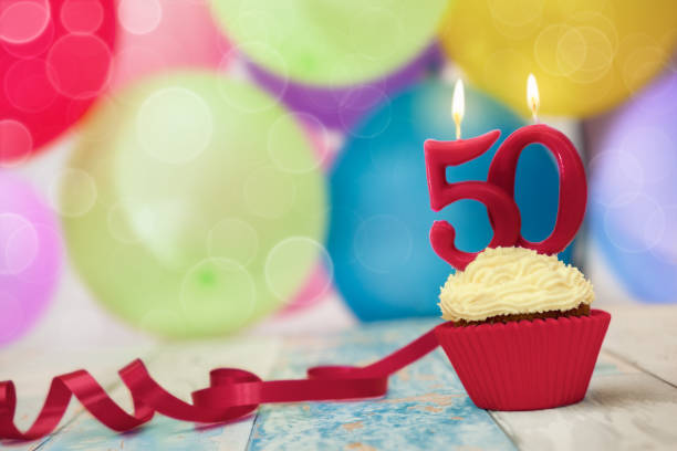 Candle on top of birthday cupcake Candle on top of birthday cupcake, celebration of fiftieth birthday 50th anniversary photos stock pictures, royalty-free photos & images