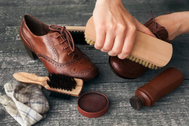 istock Craftsman cleaning shoe with brush 847335480