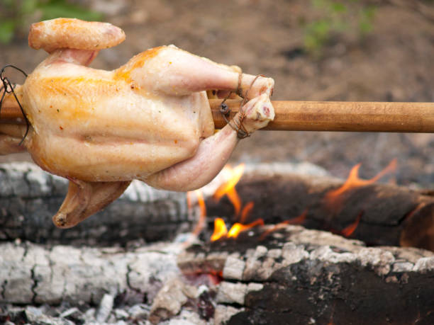 Grilled chickens Grilled chickens on skewer smoking meat rotisserie barbecue grill stock pictures, royalty-free photos & images