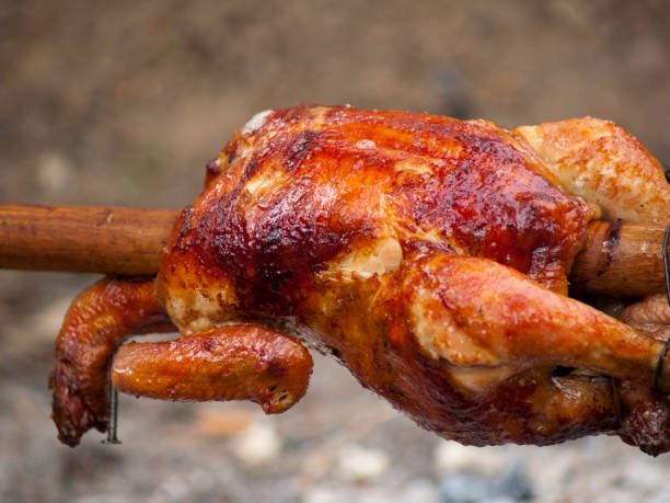 Grilled chickens Grilled chickens on skewer smoking meat rotisserie barbecue grill stock pictures, royalty-free photos & images