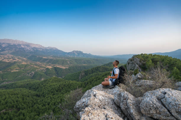 istock Traveler with backpack looks on a mountain peak 847349128