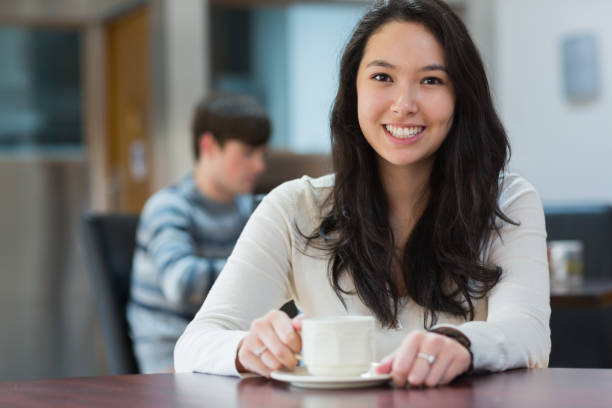 istock Happy student sitting in a coffee shop 847350560