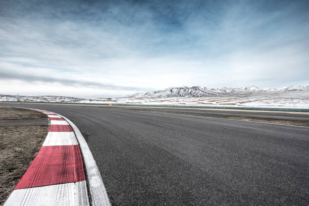 istock empty asphalt road with snow mountains in blue sky 847357674