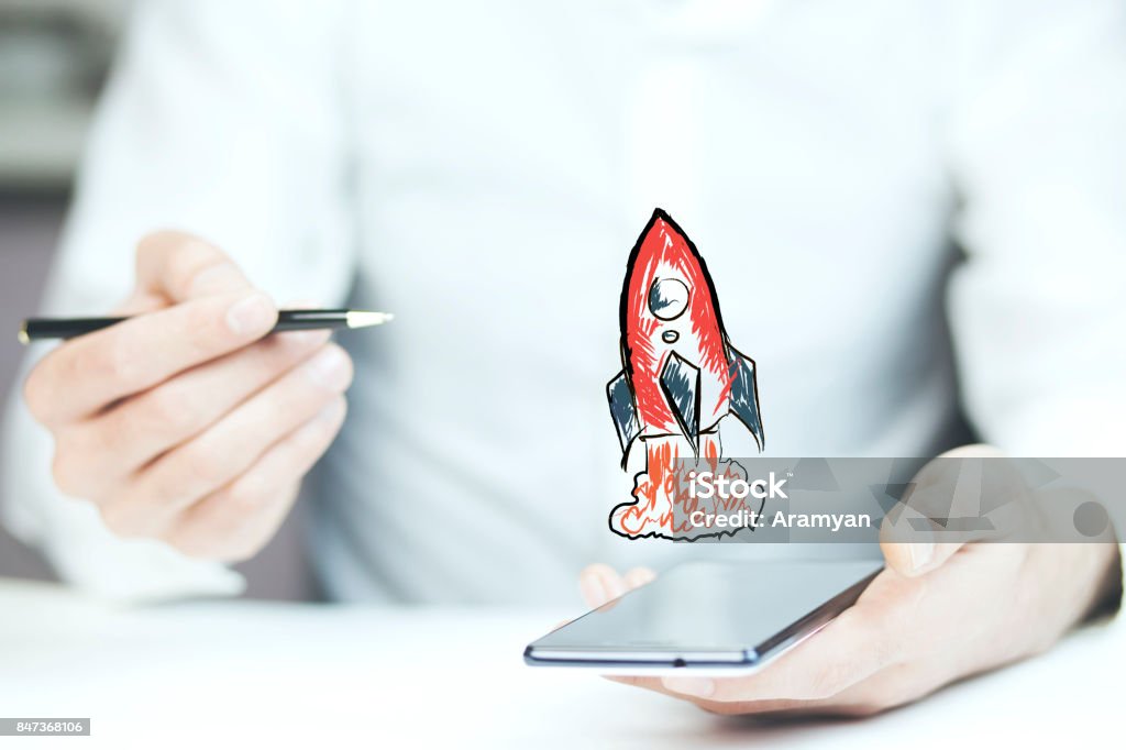 Businessman hand phone with red rocket Business man hand phone with red rocket Entrepreneur Stock Photo