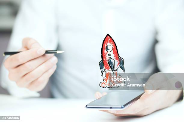 Businessman Hand Phone With Red Rocket Stock Photo - Download Image Now - Entrepreneur, New Business, Finance
