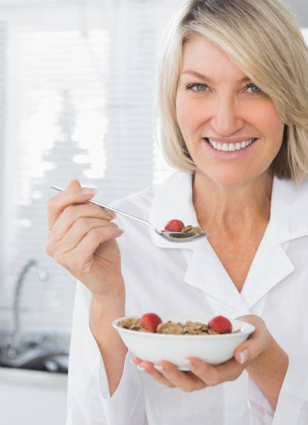 istock Smiling woman having cereal for breakfast 847368866