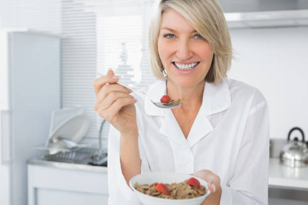 istock Cheerful blonde eating cereal for breakfast 847368930