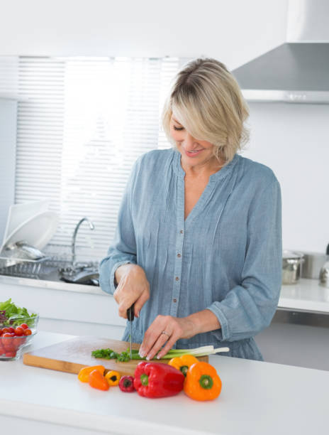 istock Cheerful woman preparing vegetables 847369426