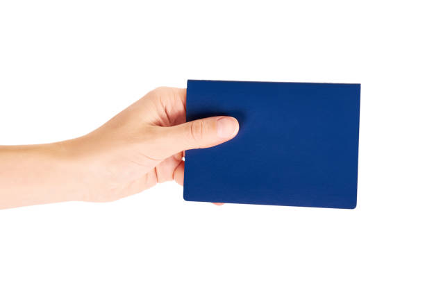 istock blue international passport in hand isolated on white background 847376850