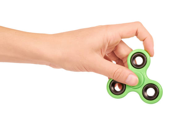 istock green fidget spinner in hand isolated on white background 847379576
