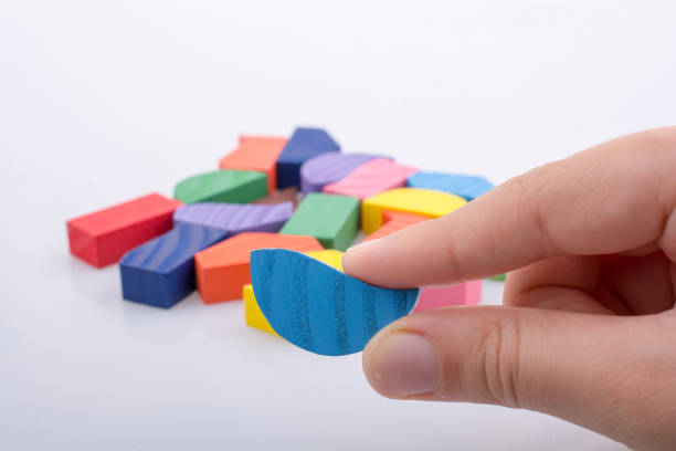istock Colorful pieces of a logic puzzle in hand 847383372