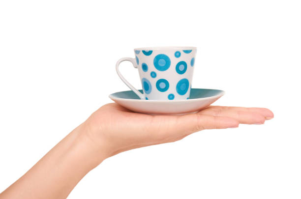 istock color cup and saucer in hand isolated on white background. 847386274