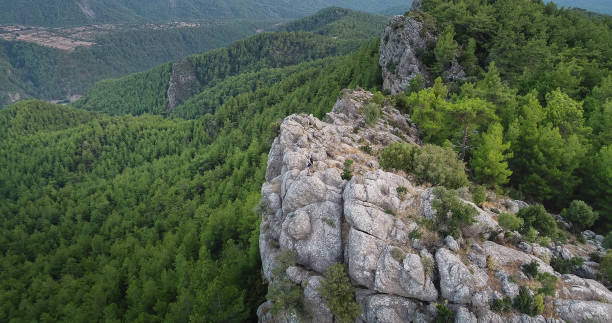 istock Traveler with backpack looks on a mountain peak aerial view 847387784