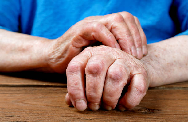 istock Hands of an old woman close-up on a table 847390470