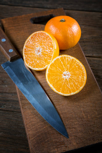 istock tangerine cut knife on an old table closeup 847390692