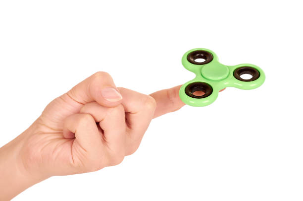 istock green fidget spinner in hand isolated on white background 847391256