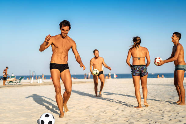 istock Men bouncing soccer ball on beach, Rio de Janeiro, Brazil 847397040