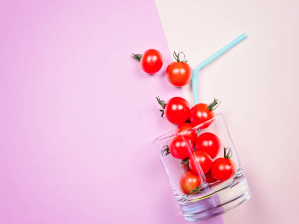istock Tomato juice or smoothie, cherry tomato in drink glass with straw 847400314